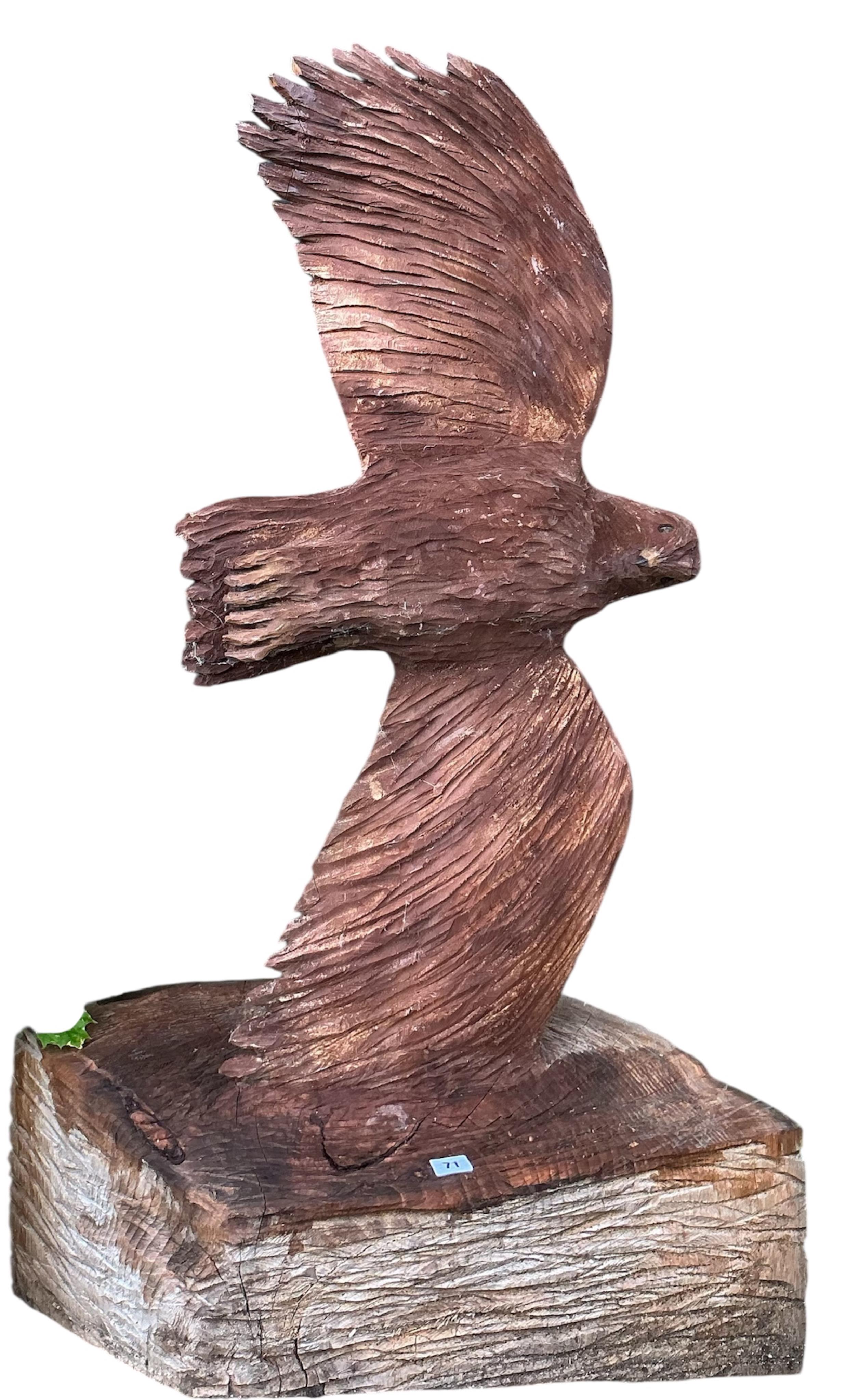 A chainsaw carving of an eagle in flight, height 170cm